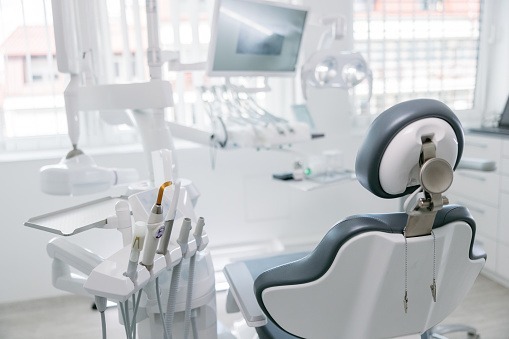 Modern dental drills and empty chair in empty dentist’s office